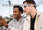 Man showing his friend his cellphone