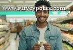 Man at grocery store holding gift card