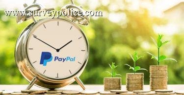 Clock with PayPal logo next to stack of coins