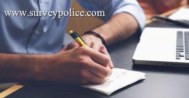 Man writing tips next to laptop