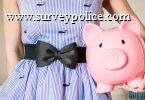 Woman holiding pink piggy bank